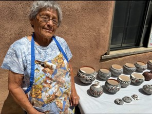 Frances Concho, Lucas Patricio's mother, at Acoma Pueblo with her pottery